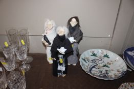 Three pottery figures of women carrying birds