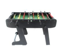 A Viavito 4ft folding football table. Comprising 2 custom made teams of 11 players in the form of