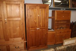 A modern pine two door wardrobe