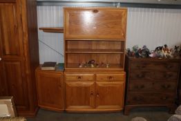 A light Ercol display cabinet fitted two short dra