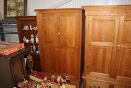 A modern oak two door wardrobe fitted single drawe