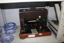 A Singer sewing machine in fitted case, sold as a