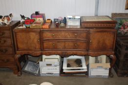 A walnut veneered serpentine fronted sideboard fit