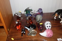 A collection of various glass paperweights in the