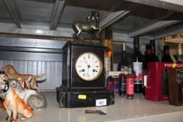 A black slate two hole mantel clock having horse s