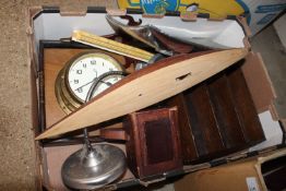 A box containing a brass bulkhead style clock, mod