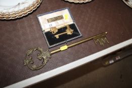 A pair of cased gilded brass keys with Crown motifs in presentation box and a large ornate brass
