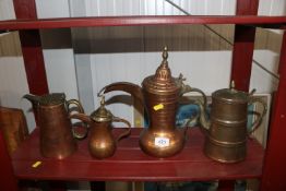 Four copper and brass Eastern coffee pots