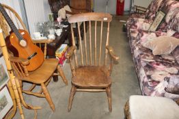 An elm seated stick back elbow chair