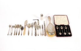 A cased set of six silver bean end coffee spoons, a silver spot hammered mounted brush, a cut