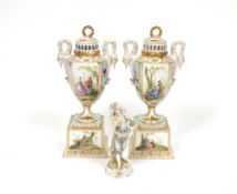A pair of Continental porcelain urns, decorated with panels of romantic garden settings and swan