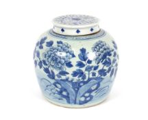 A large Chinese blue and white jar, having prunus decoration together with an associated lid, 23cm
