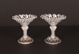 A pair of fine and rare 18th Century sweetmeat glasses, having dog tooth rims above ogee bowls,