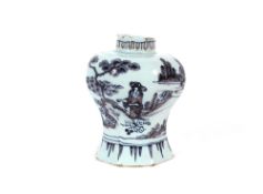 A late 17th Century Delft vase, of octagonal shape, the light blue ground painted with underglaze