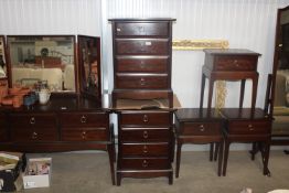 A pair of stag bedside chests fitted three drawers