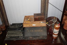 A Remington Home portable typewriter; a wooden cut