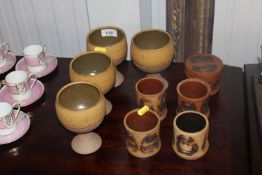 Four Studio Pottery goblets; four Studio Pottery pots together with a pot and cover