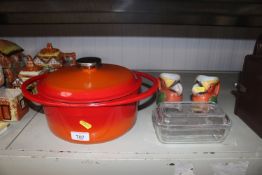 A cast iron twin handled cooking pot and cover; a