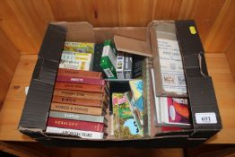 A box containing various books, postcards, playing