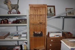 A pine open fronted bookcase of narrow proportions