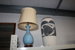 A pottery table lamp and shade together with a pot