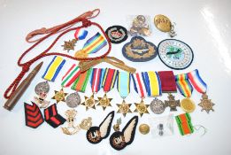 A box of various military badge, buttons, medals e