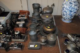 A quantity of various pewter tankards, teapot, a spice tin etc.