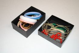 Two boxes containing various bangles, a pair of 92