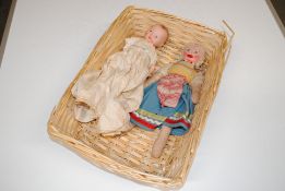A basket containing two dolls