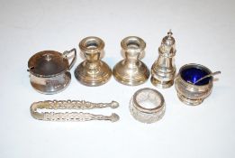 A pair of silver candlesticks with weighted bases