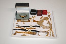 A box containing various gold tone jewellery inclu