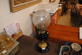 A Victorian oil lamp having blue glass reservoir,