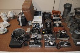 A quantity of various cameras to include Canon, Ol