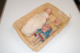 A basket containing two dolls