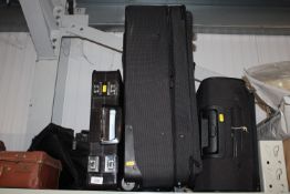 Two suitcases a briefcase and one other