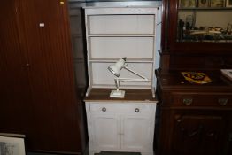 A part painted dresser raised on cupboard base fit