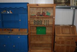 A modern pine open fronted book case with fitted s