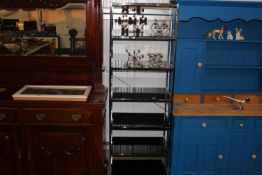 A metal framed and smoked glass shelving unit