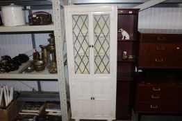 A white painted and leaded glazed corner cabinet r
