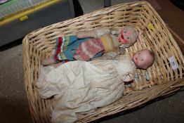 A basket containing two dolls