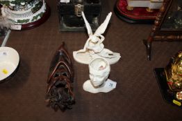 A small leather face mask; a pottery vase in the f