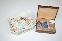 A box containing cigarette cards and trade cards a