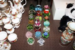 A collection of various paperweights to include We