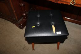 A button down upholstered sewing box and contents