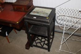 An Oriental lacquered two tier stand