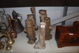 Seven wooden candle stands