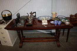 A mahogany dining table raised on stretcher base