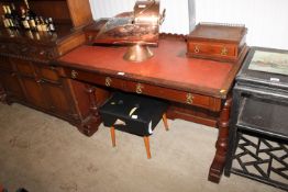 A Victorian mahogany desk having red leatherette i