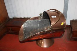 A copper coal scuttle
