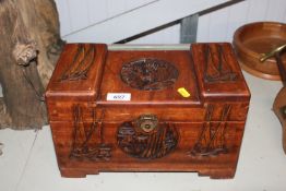 An Oriental carved wooden storage box